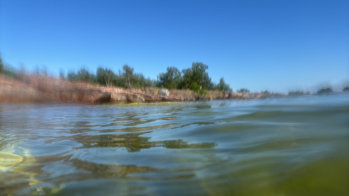 Blurry photo of a rocky island from water level.